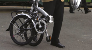 man holding folding bike